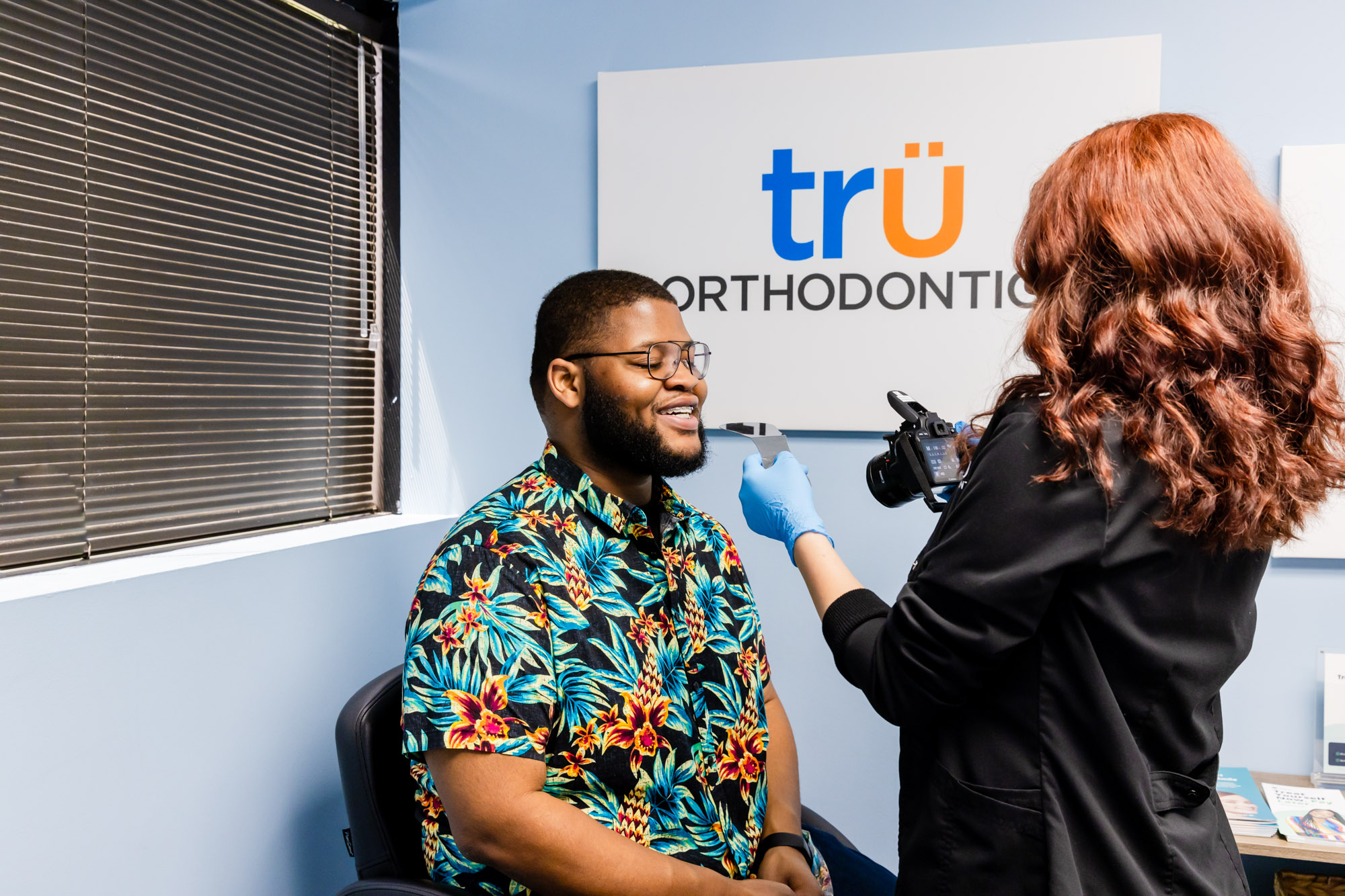 Orthodontist in Herndon, fitting adult braces on a patient