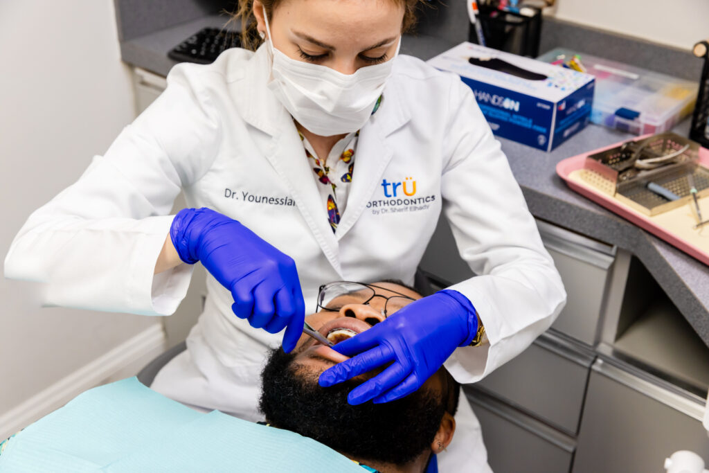 Orthodontist fitting adult braces in West Springfield, VA.
