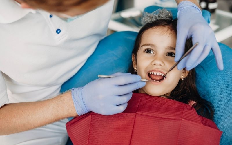 Child smiling during early orthodontic treatment in Herndon VA consultation